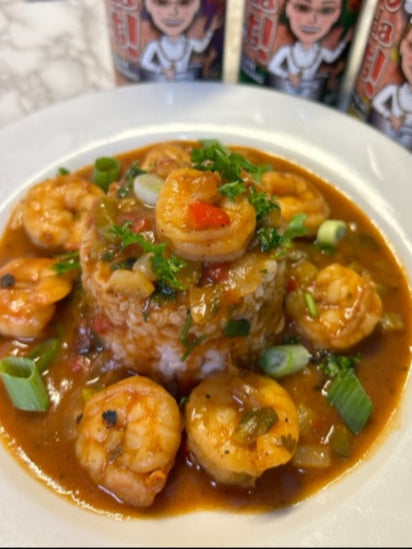A dish of Louisiana style shrimp creole with rice topped with shrimp, garnished with herbs and spices, and two cans of Pat-n-da pot creole sauce in the background.